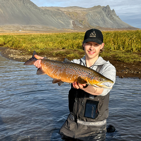 Guide with a kid and his first caught Atlantic Salmon